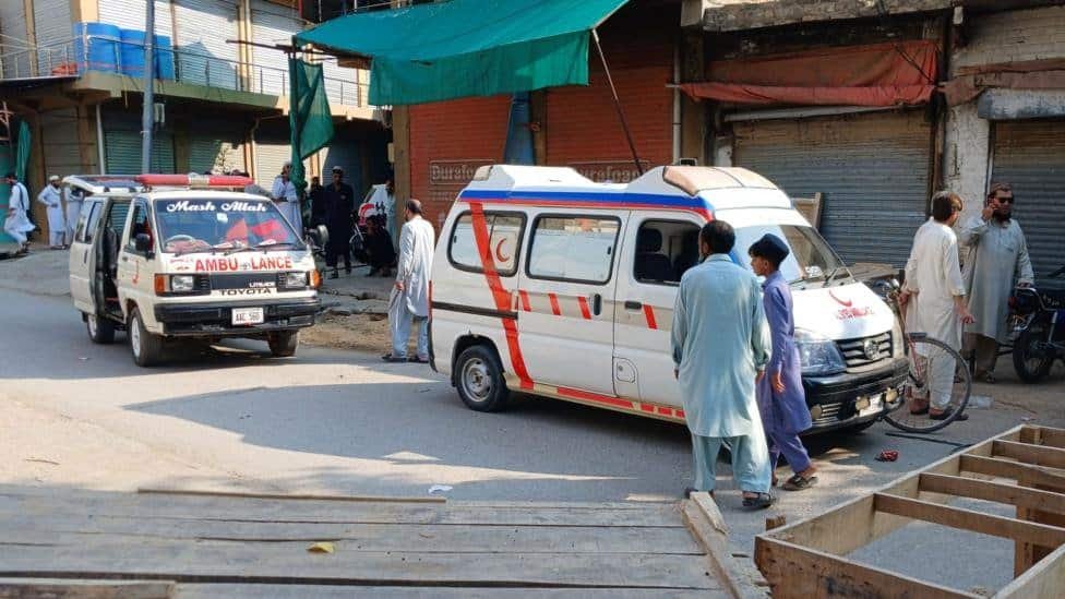 Ambulances and emergency workers transport victims after a mosque bombing in Kohat, Pakistan.