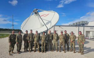 U.S. Space Force personnel stand near equipment associated with military space operations.
