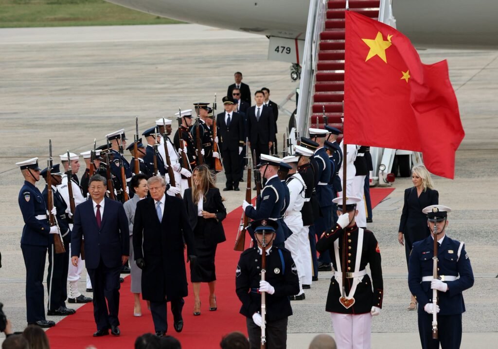 Donald Trump and Xi Jinping walking together during an arrival ceremony at Joint Base Andrews.