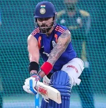 Virat Kohli in India cricket kit preparing to bat during a training session.