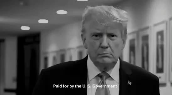 A black-and-white still from a television advertisement shows a man in a suit walking down a hallway, with on-screen text reading "Paid for by the U.S. Government."