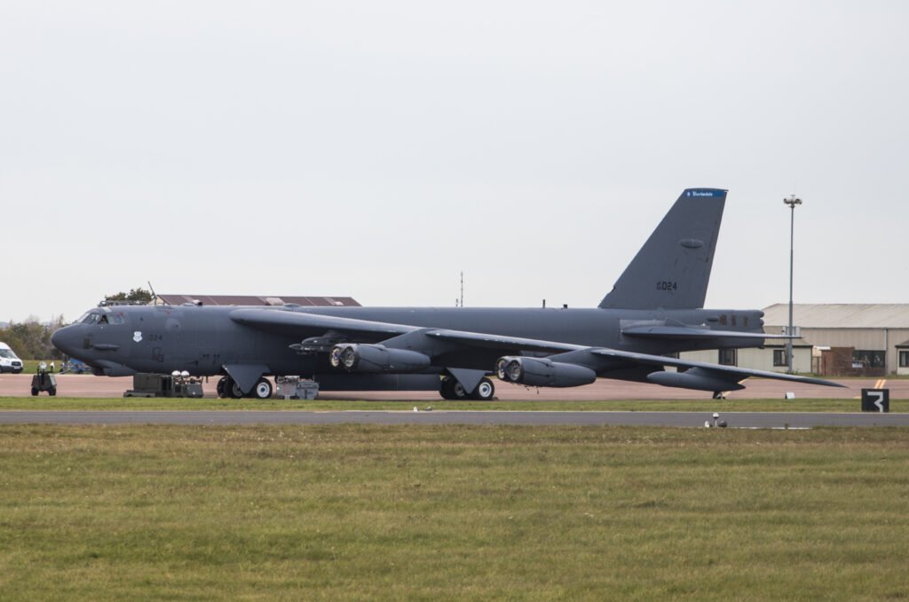 A large military bomber aircraft parked on an airfield runway.