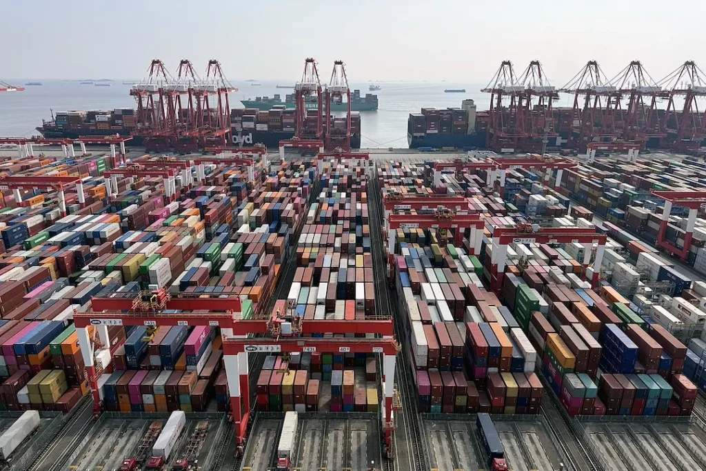 Stacked shipping containers at a commercial port terminal.