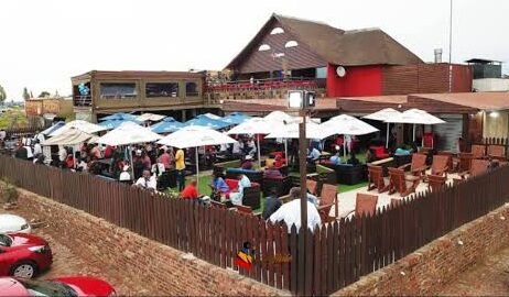 Exterior of a township tavern in South Africa at night.