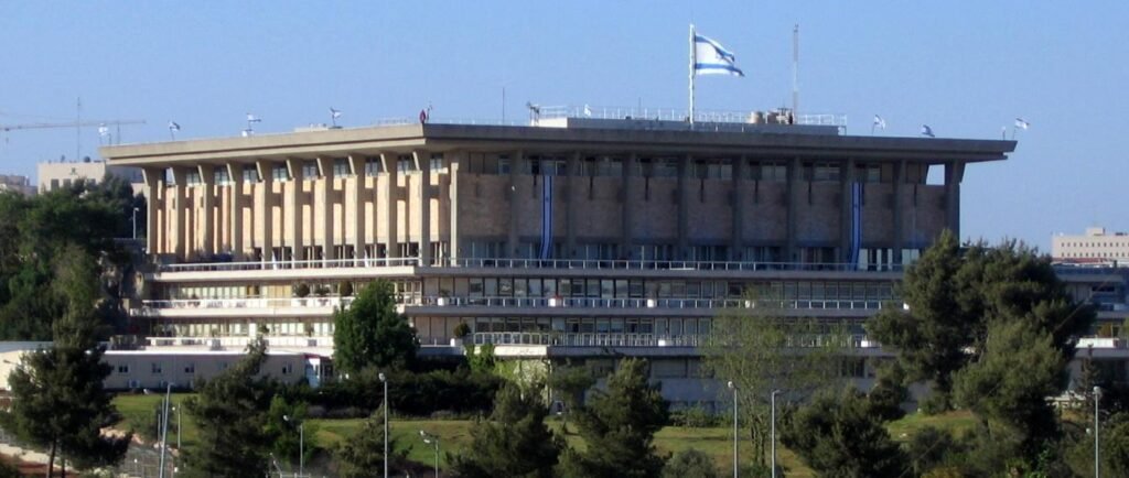 Exterior view of the Knesset building in Jerusalem under a clear sk