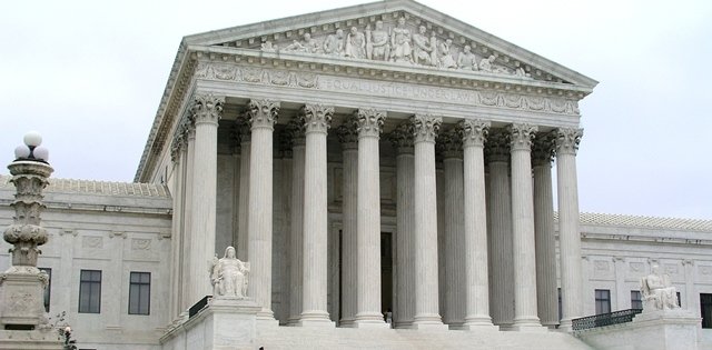 The white marble facade and columns of a federal courthouse.