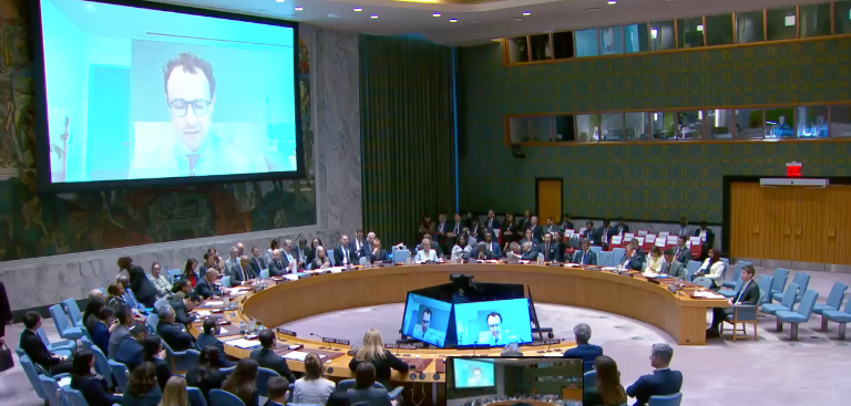 Dario Amodei appearing on a large screen during a United Nations Security Council discussion on AI safety.