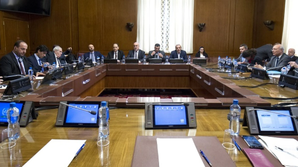 Delegates seated at a negotiating table during international peace talks.