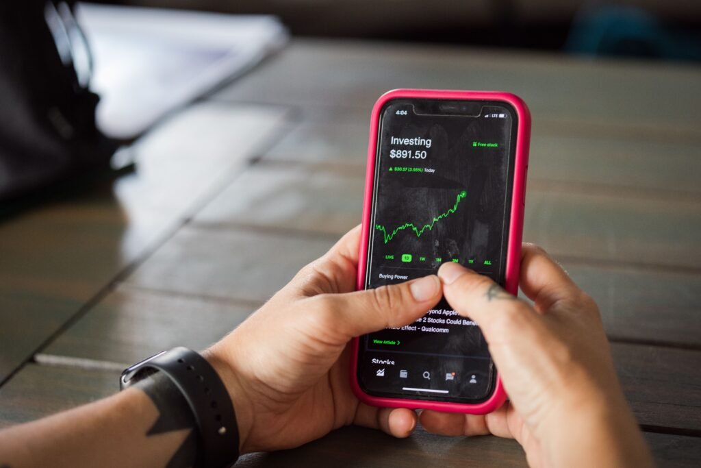 Close-up of a smartphone showing a prediction-market app with percentage-based betting odds.