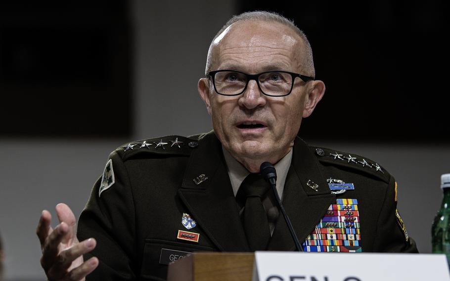 A uniformed general seated at a congressional hearing.