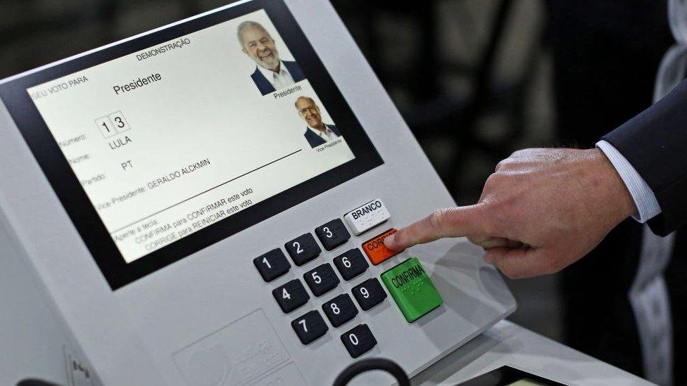 person using an electronic voting machine at a polling station.