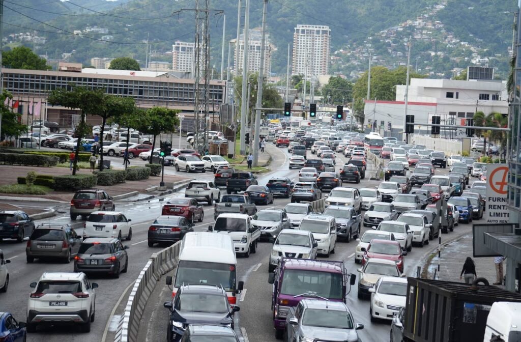 Vehicles are backed up in heavy traffic along a city roadway.
