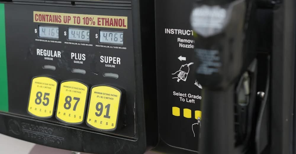 A roadside gas station price sign showing fuel prices above four dollars per gallon.