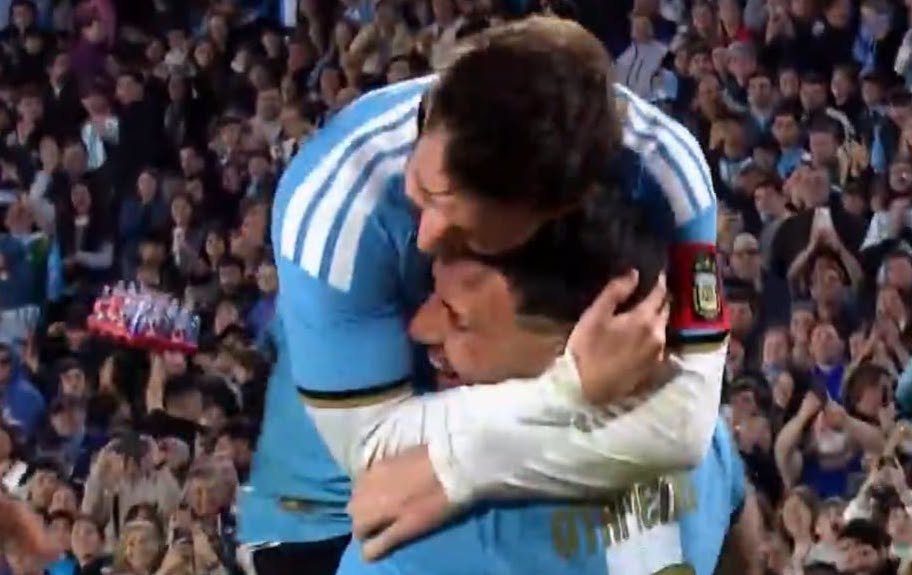 A soccer player celebrates after scoring a goal on the pitch.
