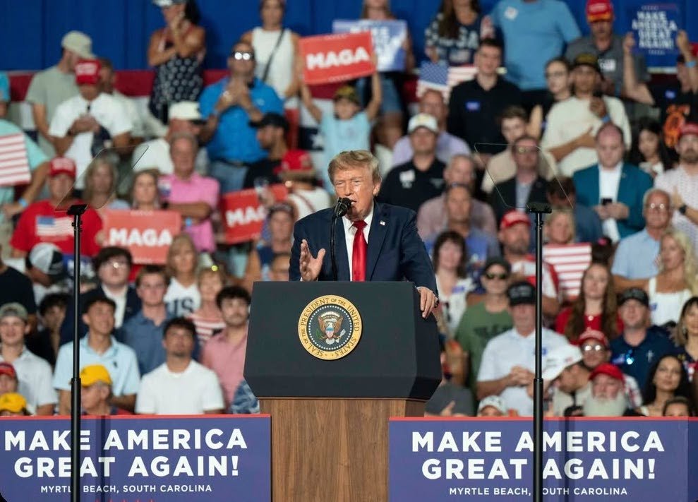 President Donald Trump gesturing at a podium during a rally.