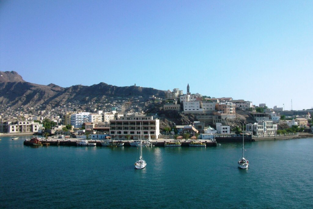 A view of a port city on the coast with buildings along the waterfront.
