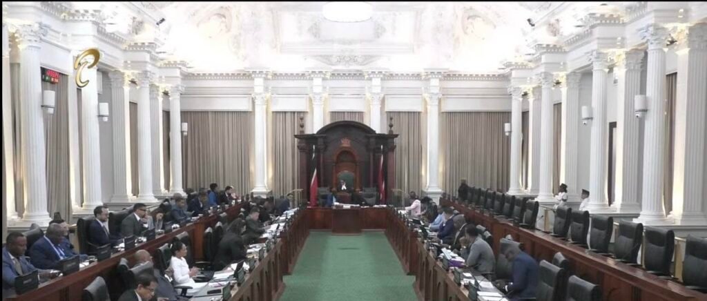Legislators seated in rows inside a formal parliamentary chamber.