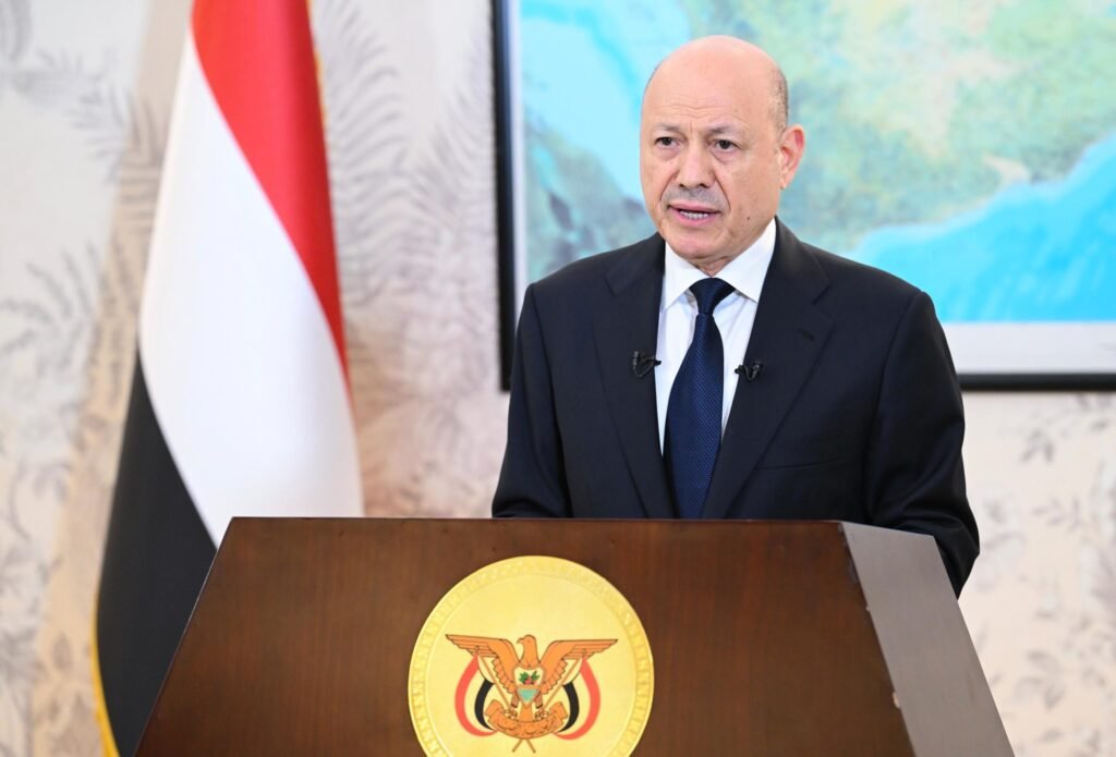 A man in formal attire speaks during a televised government address.
