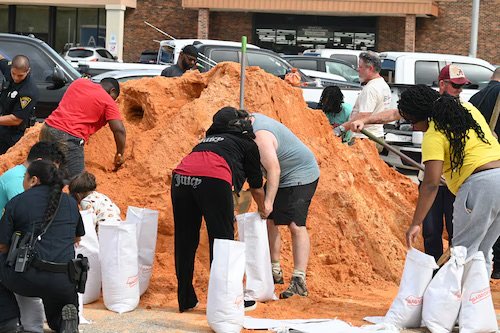 Residents and emergency personnel prepare coastal properties for Hurricane Isaias.