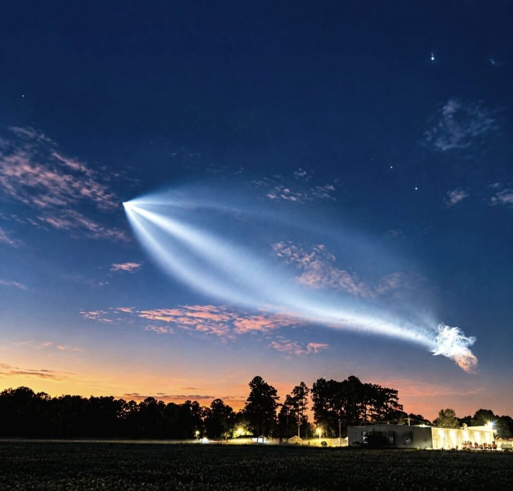 Glowing rocket plume spreading across the sky in a shape resembling a jellyfish.