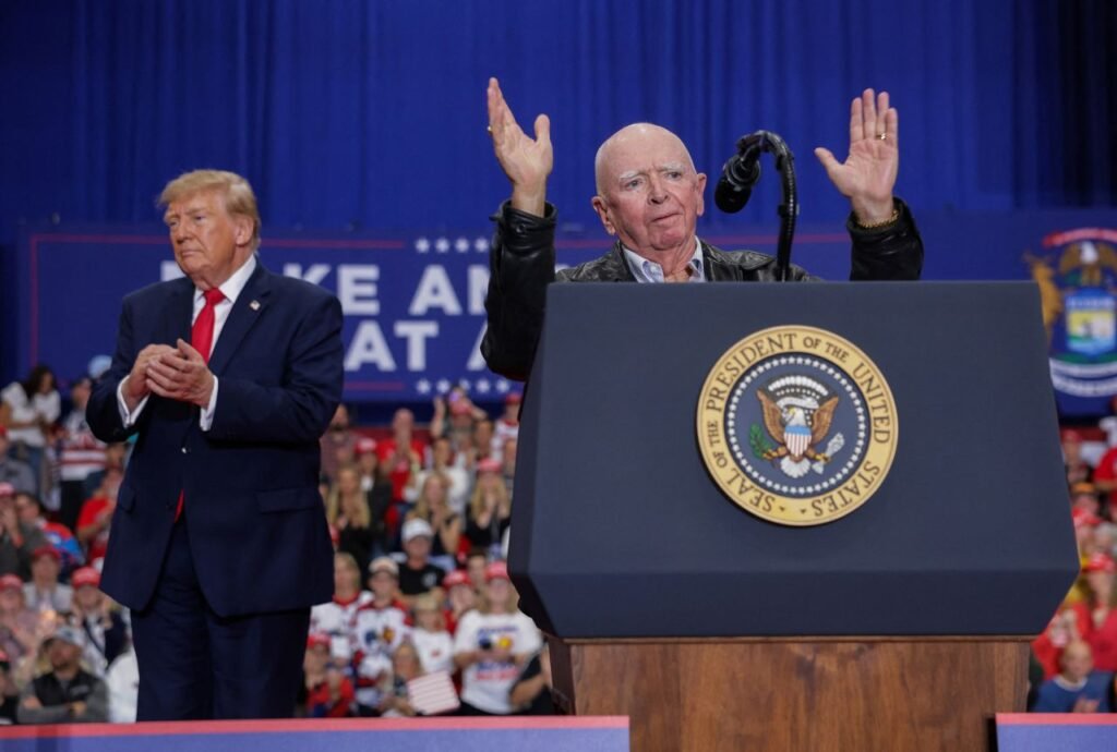 An older man speaking at a podium at a campaign rally.
