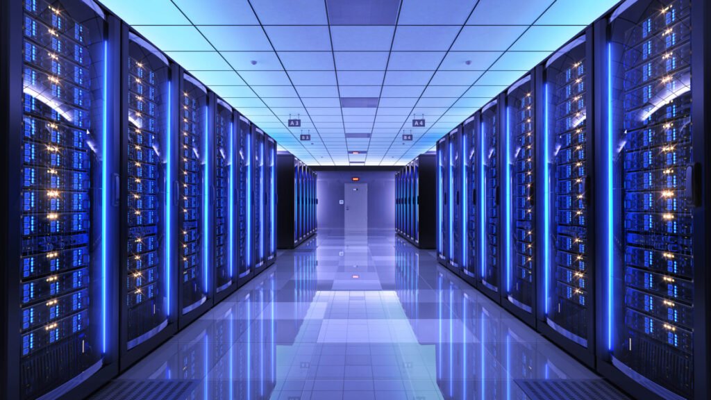 Rows of server racks in a data center with blue lighting.