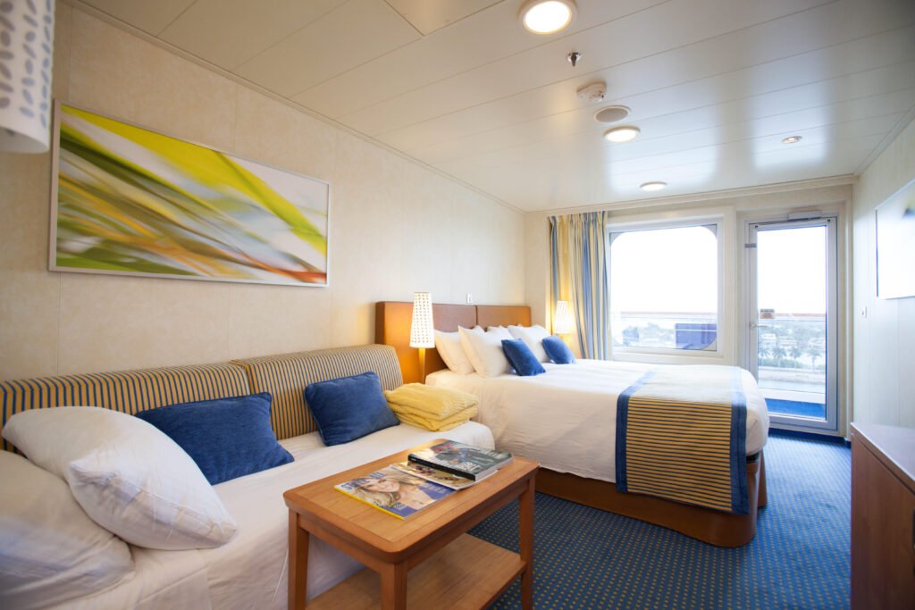 A cabin with a bed and a sea view.