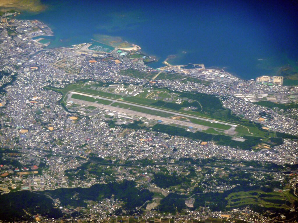 Aerial view of a military air station surrounded by a city.