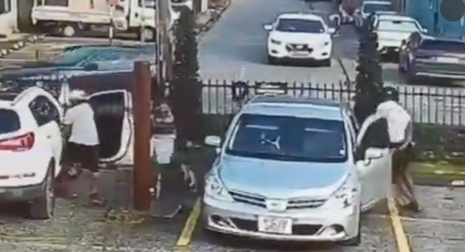 Verified still from video footage showing the reported robbery at a Maraval business.