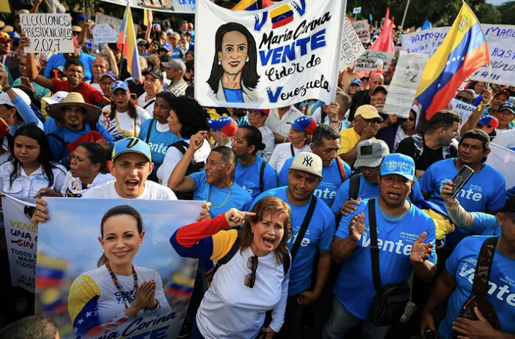 Protesters carrying a large banner with Machado’s picture on a Caracas street.