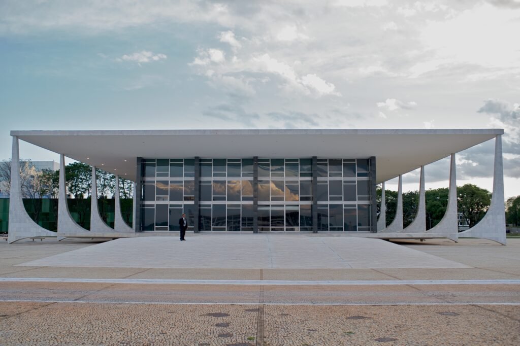 The modern white Supreme Court building in Brasília under a blue sky.