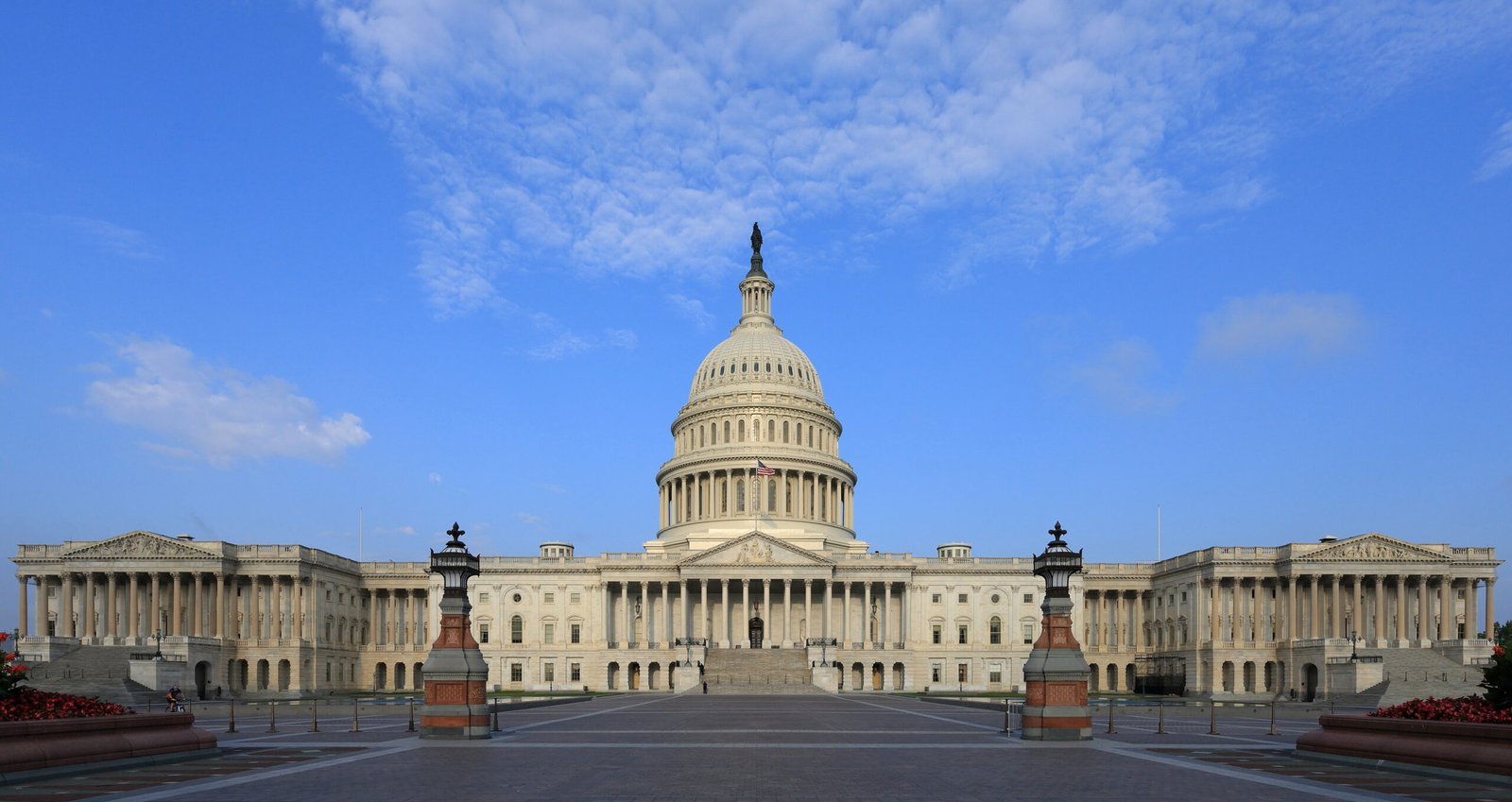 The white dome of the U.S. Capitol building against a blue sky.