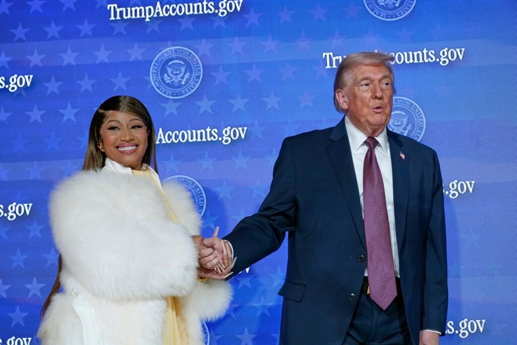 A woman in a white fur coat smiling next to Donald Trump