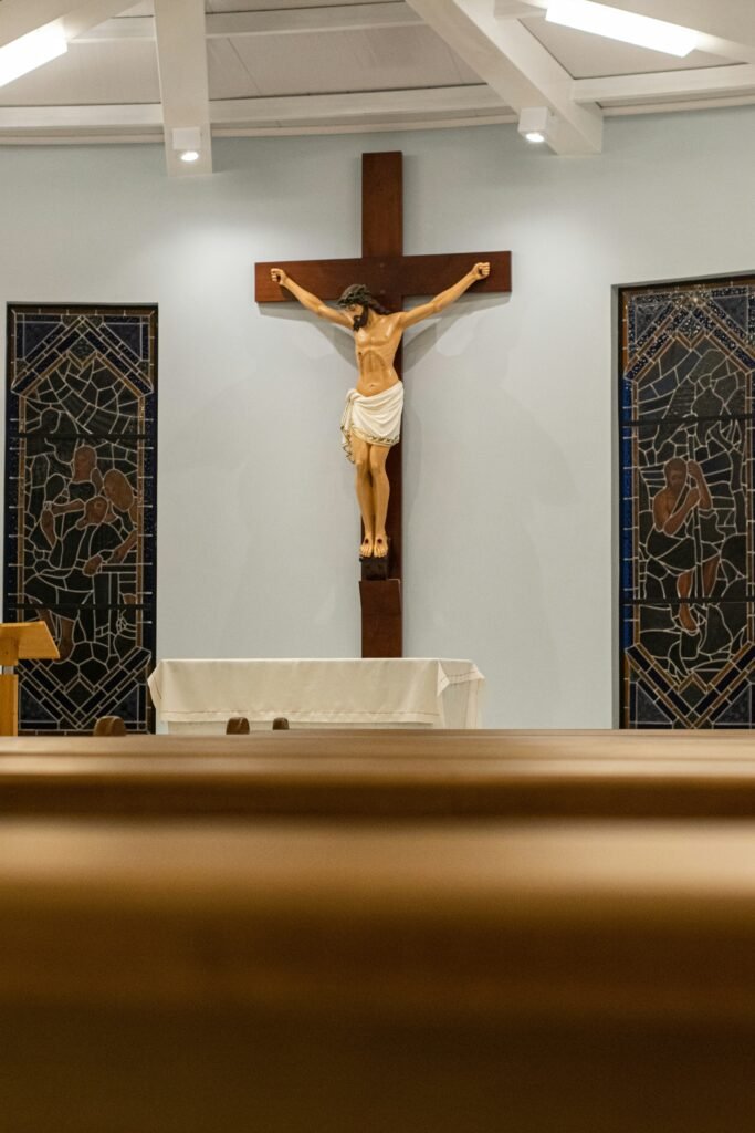 A large wooden crucifix mounted on a church wall above an altar.