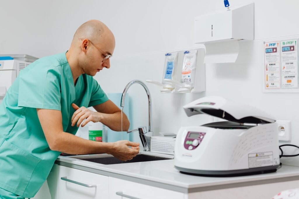 Health care professional washing hands with soap and running water to reduce the spread of infectious bacteria.
