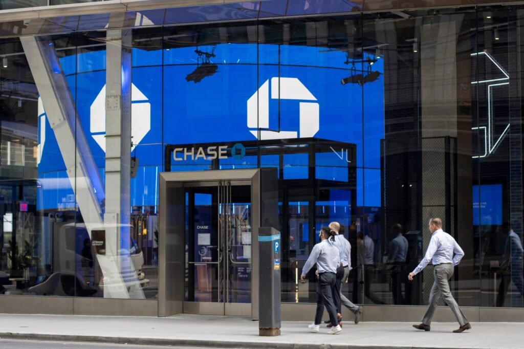 The glass-fronted exterior of a bank branch on a city street.