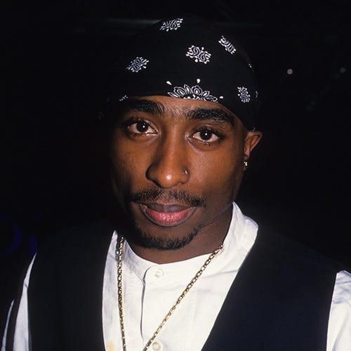 Tupac Shakur, wearing a bandana and a dark jacket, looking toward the camera.