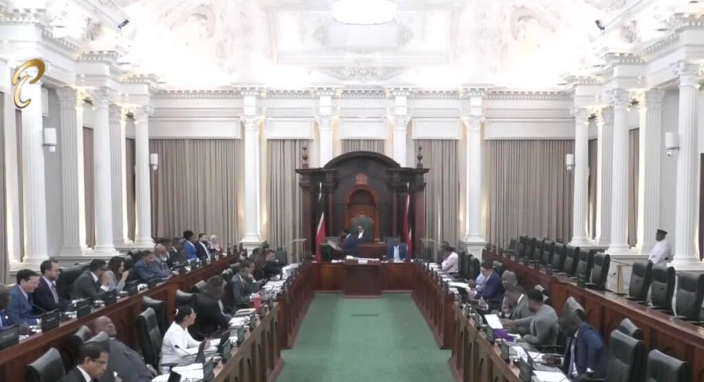 Legislators seated in rows inside a formal parliamentary chamber.